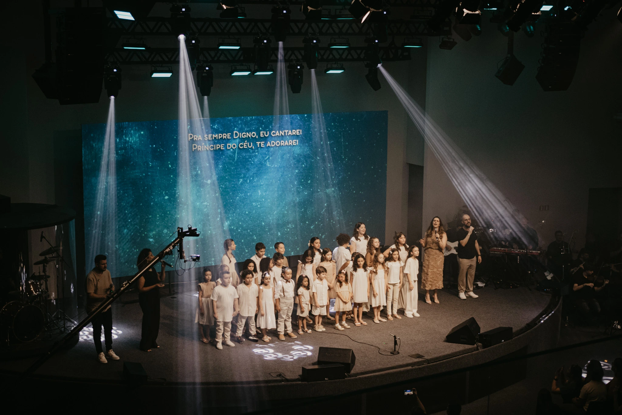 Apresentação de coral infantil no culto de Natal da igreja Assembleia de Deus Alto do Ipiranga (ADAI) com crianças cantando e decorando o ambiente